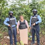 Woman guarded by police